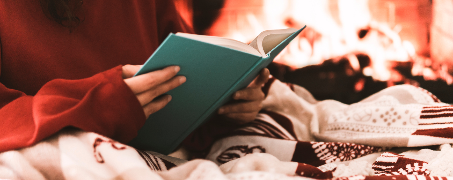 Person reading by the fireside